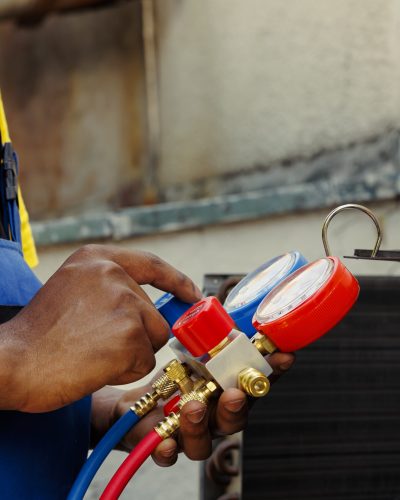 Close up of manometers able to detect hvac system moisture intrusion, refrigerant not circulating and other issues. Trained engineer using barometer set to read air conditioner pressure levels