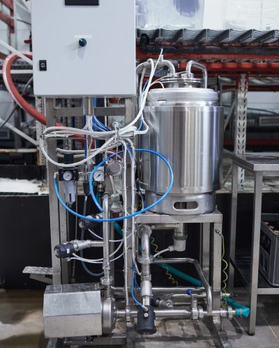 Vertical background image of distillation equipment at industrial brewery workshop, copy space