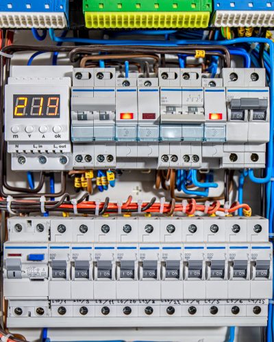 Switchboard equipment. Shield for enterprise electrification. Switchboard for control over electrical equipment. Labeled panel with wires and switches at enterprise.
